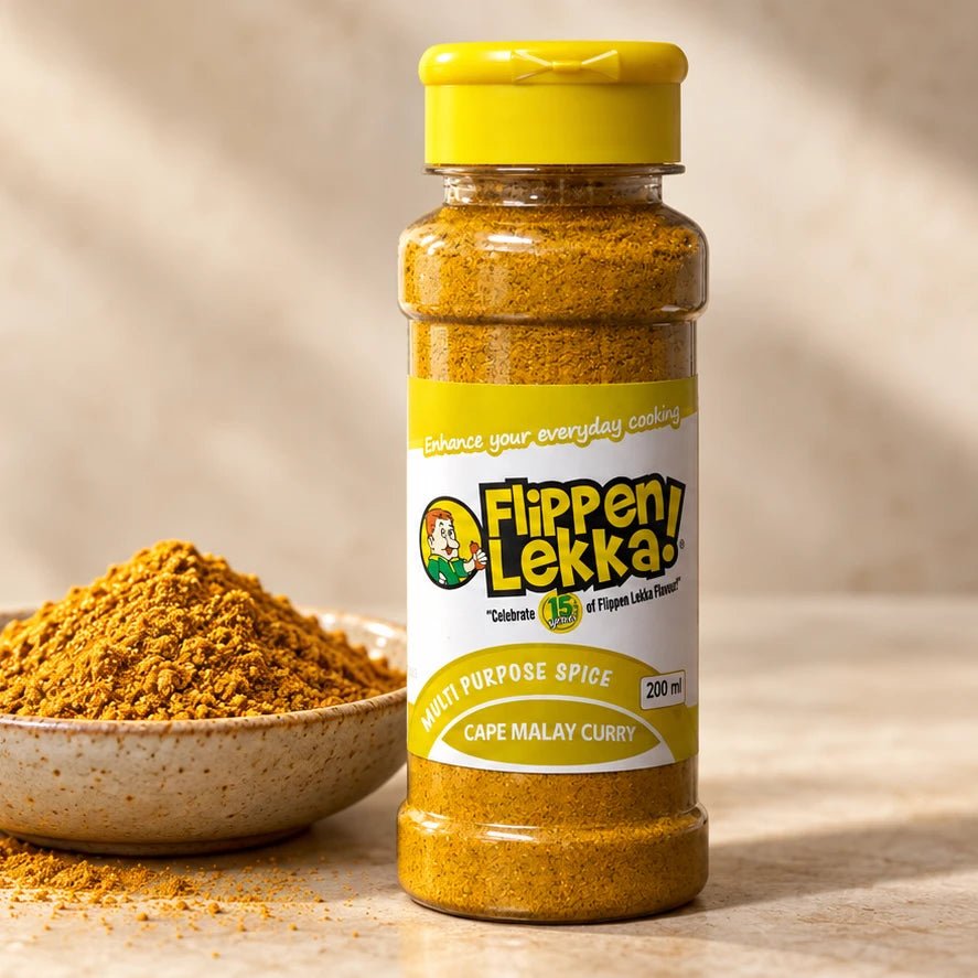 Cape Malay Curry in its yellow-capped 200 ml bottle beside a bowl of finely ground curry blend